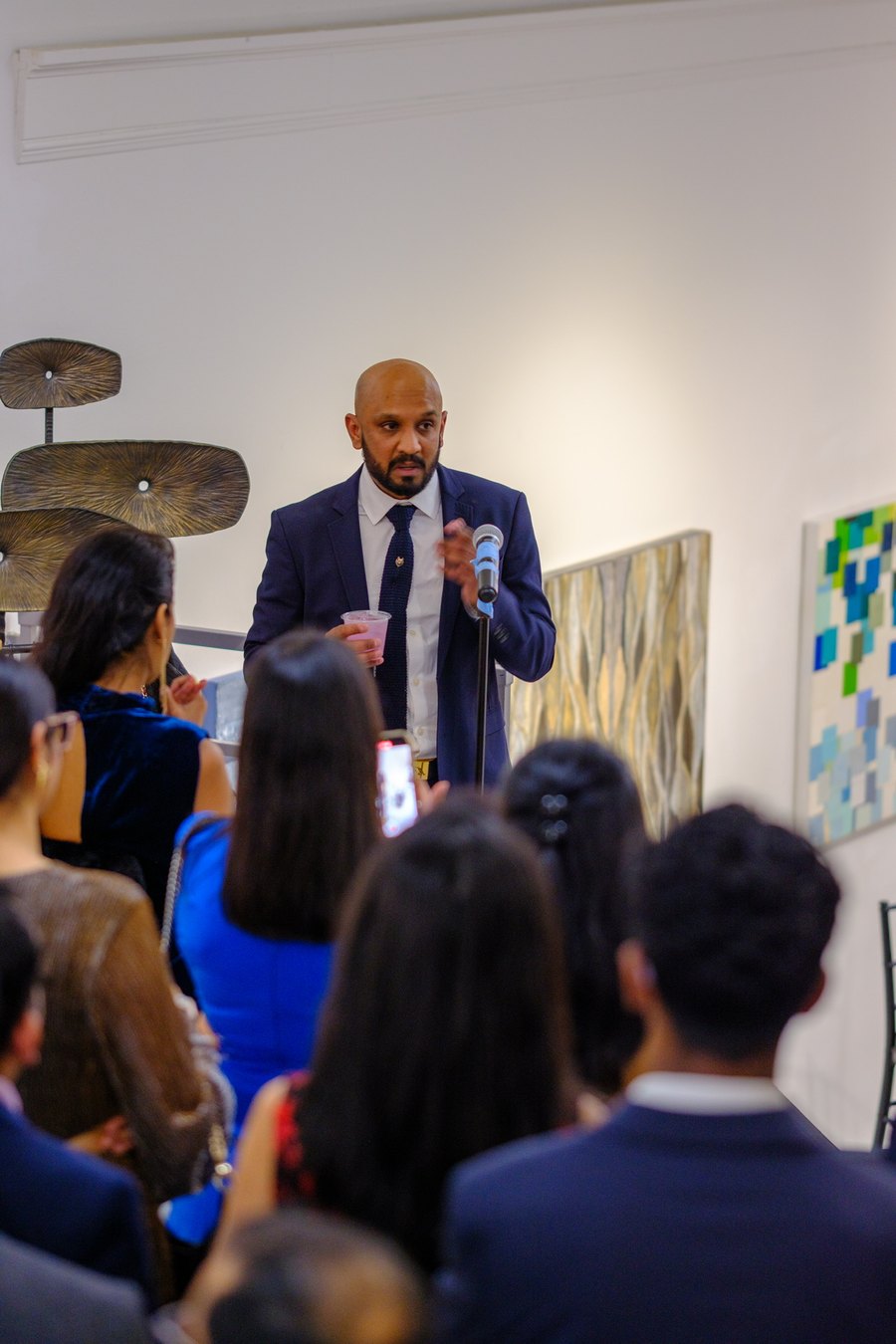Me at a microphone, talking guests through the work on opening night